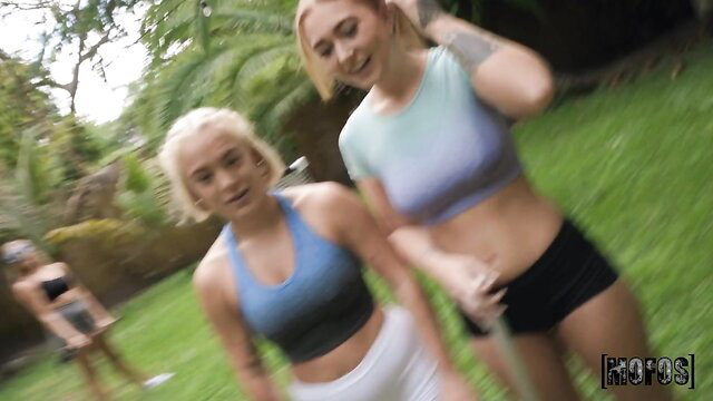 Victor Ray and blonde friend in sporty crop tops and shorts outdoors