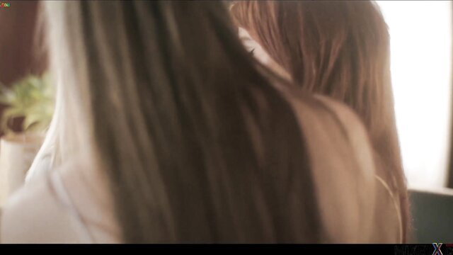 Candee Licious blonde with redhead in intimate embrace, softcore tease