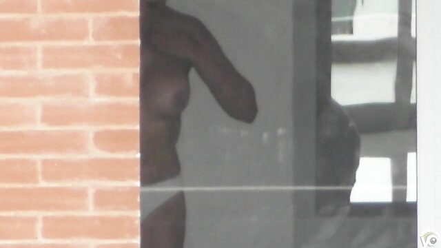 Nude black man in white briefs by window, secret amateur voyeur shot