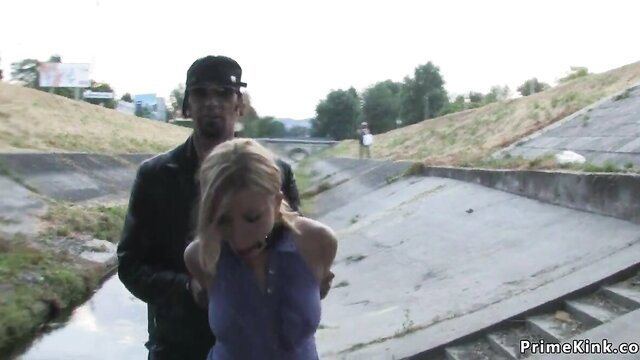 Donna Bell grabbed by man in concrete ditch outdoor public kink