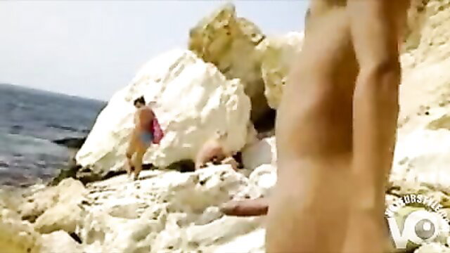Nude man exposes hard cock to bikini girls on sunny beach