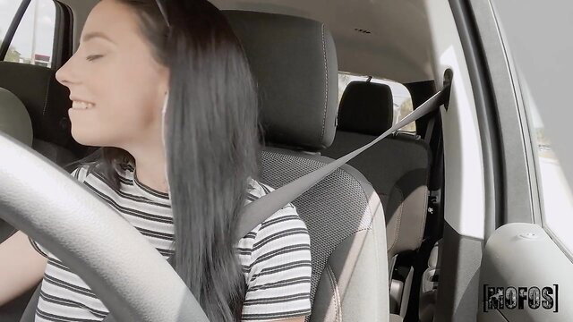 Jmac's brunette driver smiling in car, seatbelt tease