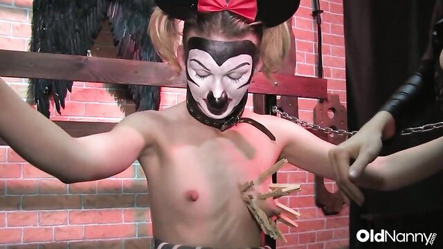 Dominika C as Minnie Mouse dominatrix tortures chained submissive in BDSM