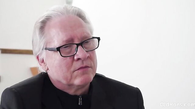 Mature Cindy Shine in suit and glasses, seductive gaze