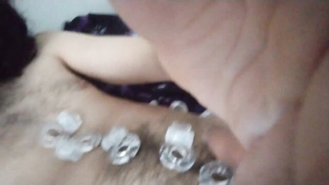 Woman's hand placing schlong rings on hairy man's cum-covered stomach