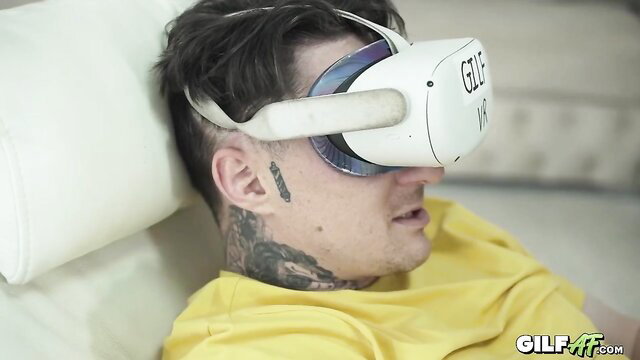 Tattooed guy wearing VR headset in hot redhead cougar tease