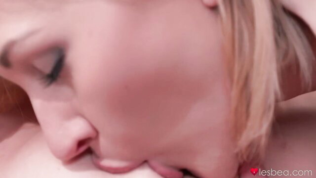 Blonde beauty in tender lesbian kiss, intimate connection