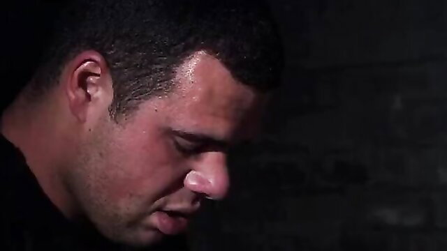 Sweaty muscular Latino man profile in dark fetish scene