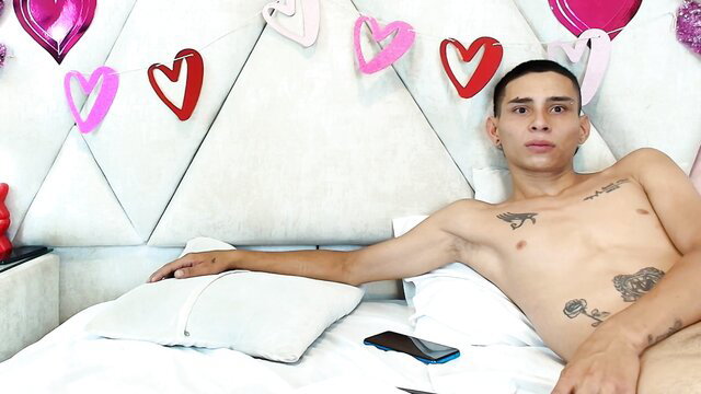Zoelucas shirtless Latino twink lounging nude on bed in hot Chaturbate thumbnail
