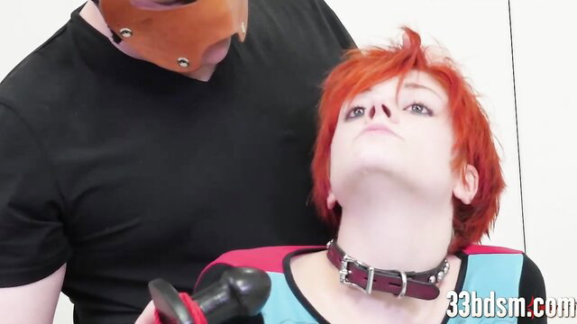 Redhead BDSM sub in collar anally toyed hard by masked dom