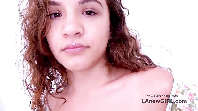 Curly-haired Hispanic teen closeup smile, off-shoulder top