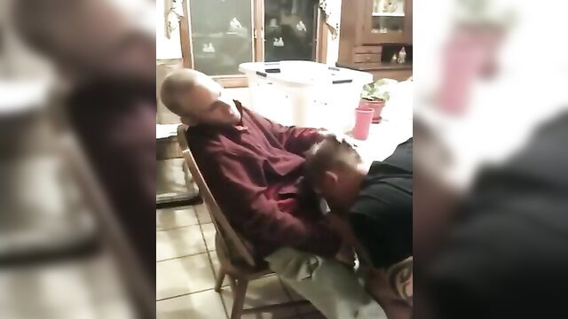 Two men helping buddy with small cock handjob in chair