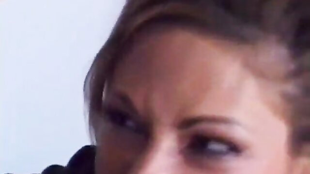 Closeup of brunette woman's intense gaze in Torment 1 adult video