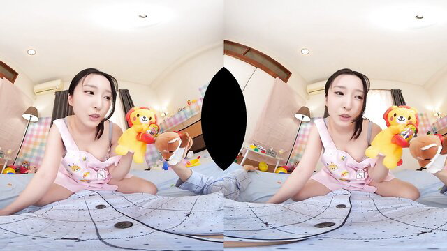 Asian VR girl in pink lingerie holds lion plush on bed, cute smiling