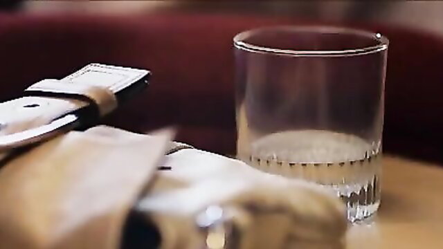 Blonde woman in lingerie belt pouring milk in glass closeup