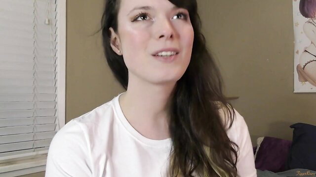 Brunette in white tee smiles at camera in taboo sister's friend virginity loss scene