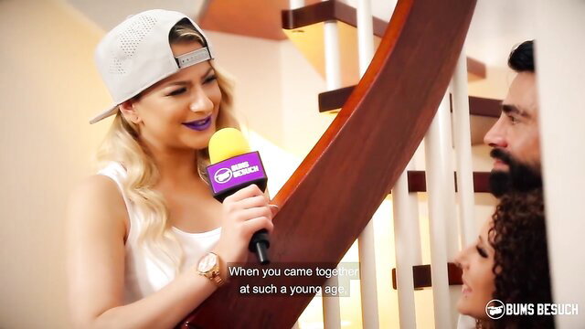Mara Martinez in white tank top and cap interviewed passionately on stairs