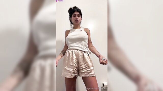 Mia Khalifa morning striptease in white tank top and gold shorts