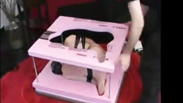 Tied up girl bound in pink frame, abused and exposed