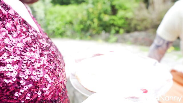 Sexy redhead Scarlet in sparkly dress with Irish bull outdoors