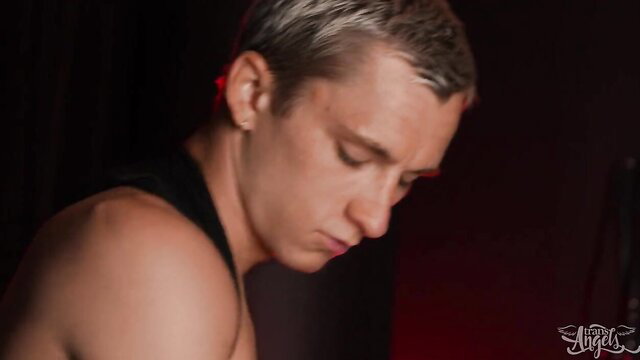 Closeup of handsome t-girl with silver hair in tank top, seductive gaze