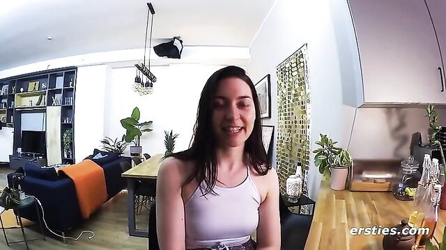 Smiling brunette babe in tank top on cam in sexy living room