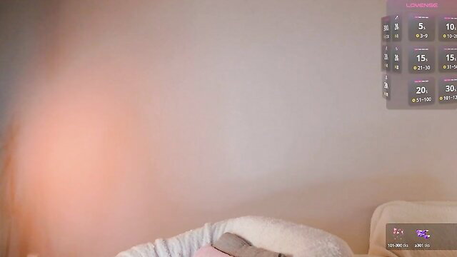 Blurry teen in lingerie on bed, pink overlay UI, seductive pose