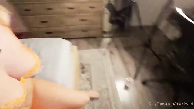 Sky Bri in yellow lingerie teasing huge tits on bed