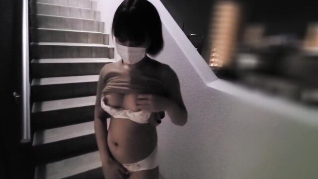Asian amateur babe in mask lifting bra, exposing perky tits on stairs