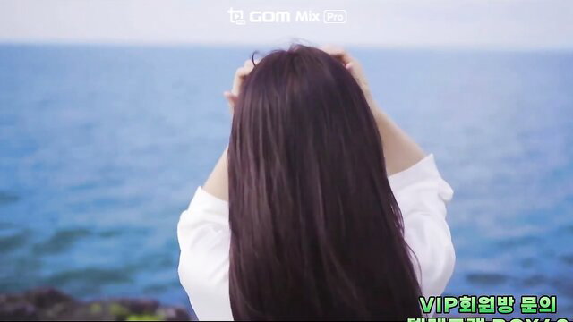 Korean beauty with long dark hair gazing at sea, white blouse, amateur style