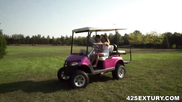 Veronica Leal in white dress on pink golf cart outdoors