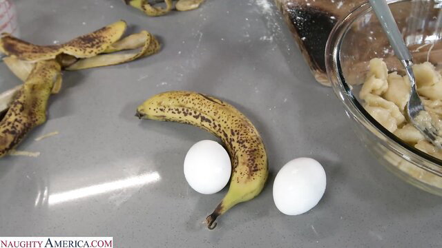 Karen Fisher preps banana bread batter with eggs in kitchen