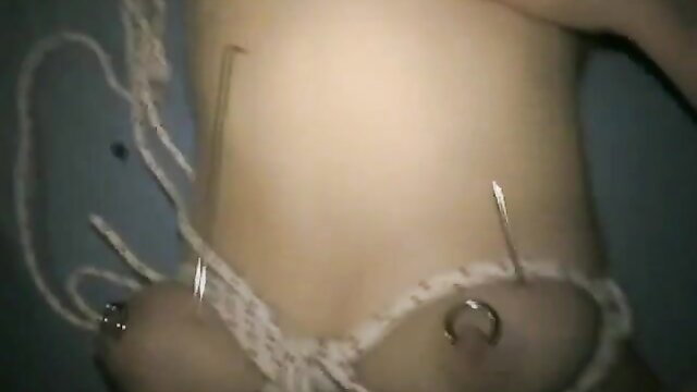 Slave's tits skewered with needles in BDSM blowjob