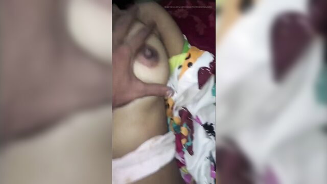 Desi aunty's nipple pinched by hand in colorful blouse closeup