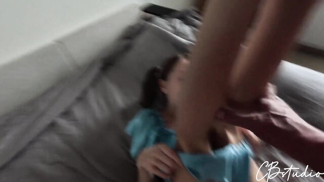 Asian girl in blue dress dominated on sofa by man gripping her legs