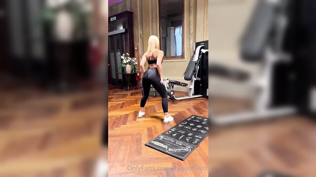 Blonde Sharna Beckman in tight leggings squats at gym