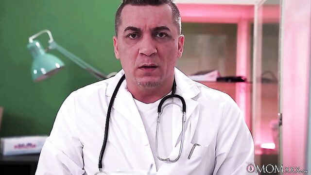 Middle Eastern doctor in white coat with stethoscope in exam room