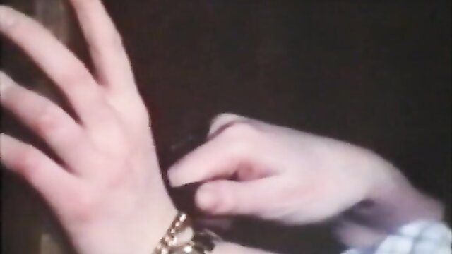 Closeup of woman's pale hands teasing crotch in dim light