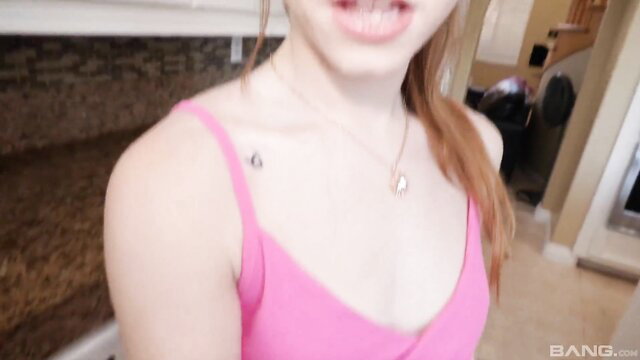 Redhead teen Myra Moans in pink tank top smiles teasingly