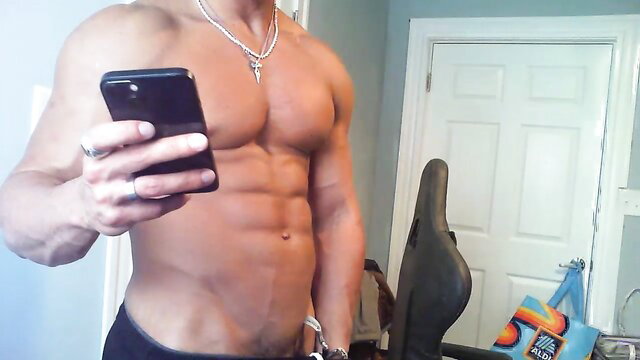 Muscular shirtless gay hunk flexing abs in tight underwear selfie