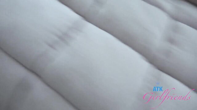 Lucy Foxx closeup on white sheets in ATK Girlfriends video