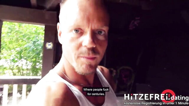 Bald German stud in tank top on balcony, hitzefrei.dating ad