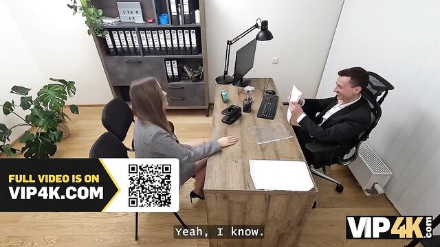 Amalia Davis in office interview, gray sweater, heels, extra credit tease