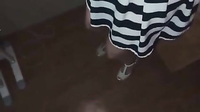 Lisa Ann in striped dress and heels, teasing ass up view