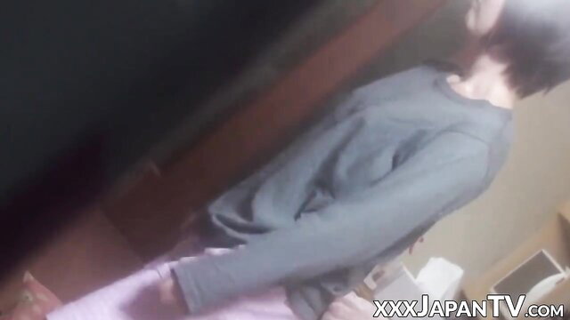 Asian babe in gray sweater and pink skirt dances before fingering pussy