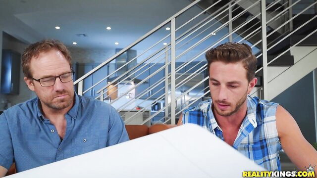 Alex Coal with two handsome men reviewing plans in sultry setup