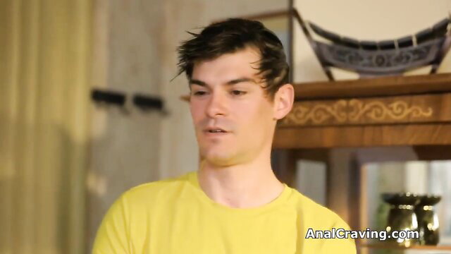 Sporty guy in yellow shirt with messy brown hair in yoga room