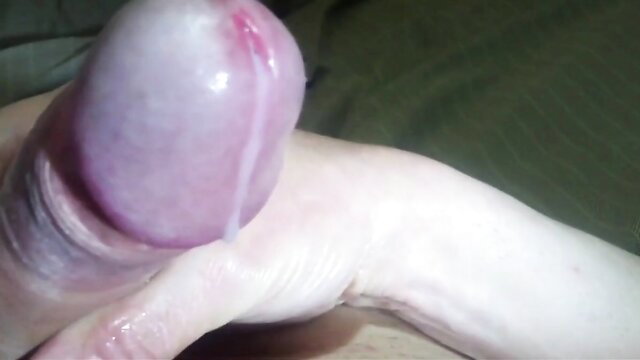 Closeup of swollen penis head with thick precum drip in cumshot tease