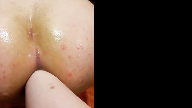 Closeup of woman's wet pussy and ass in BDSM slave play