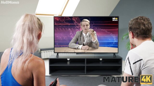 Blonde with fake tits & man watch TV on sofa, Meyoto & Malusha